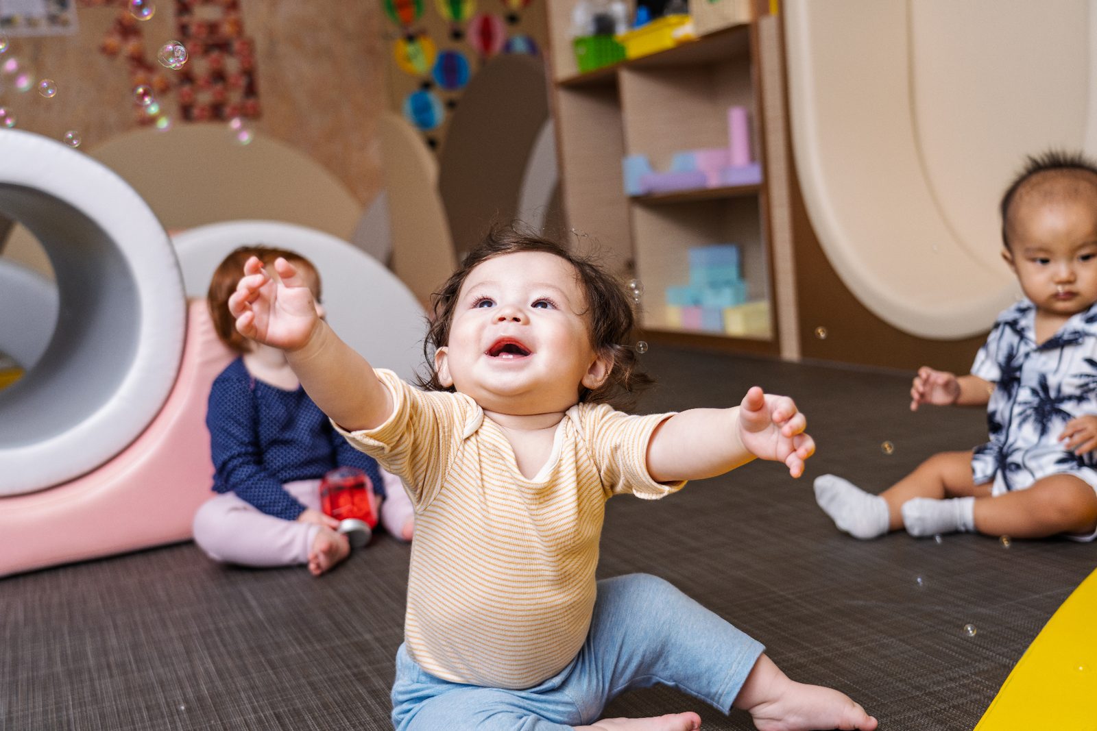 An infant exploring sensory materials