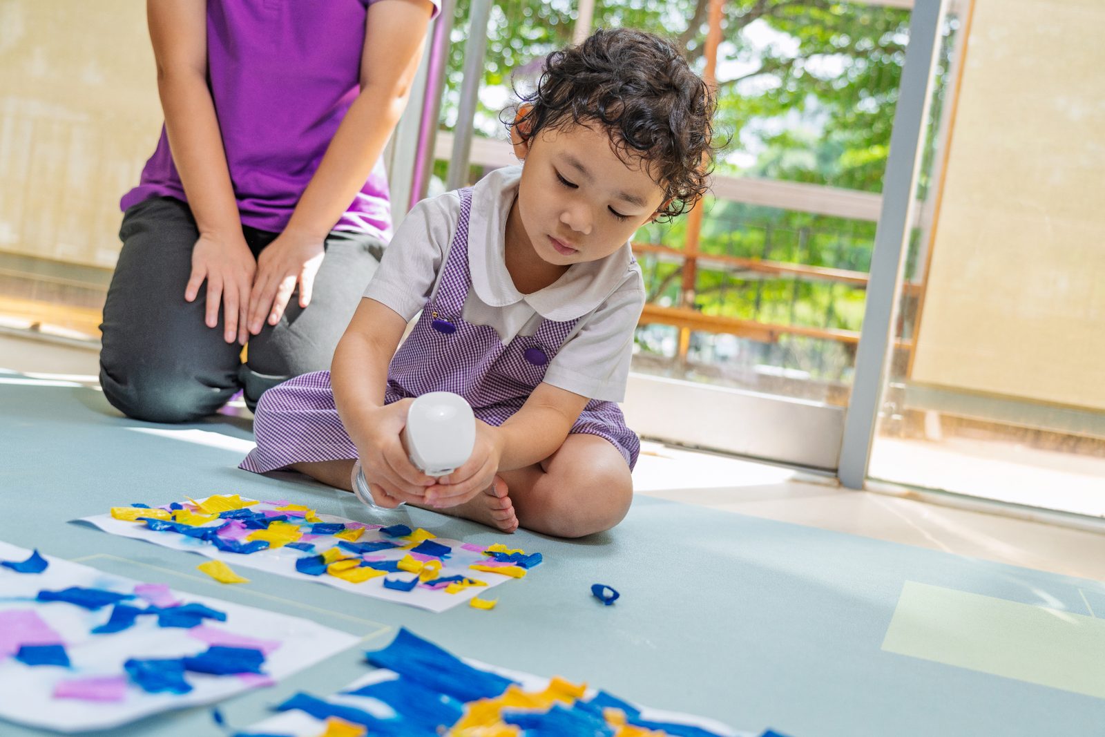 A child exploring art with a teacher at Mulberry