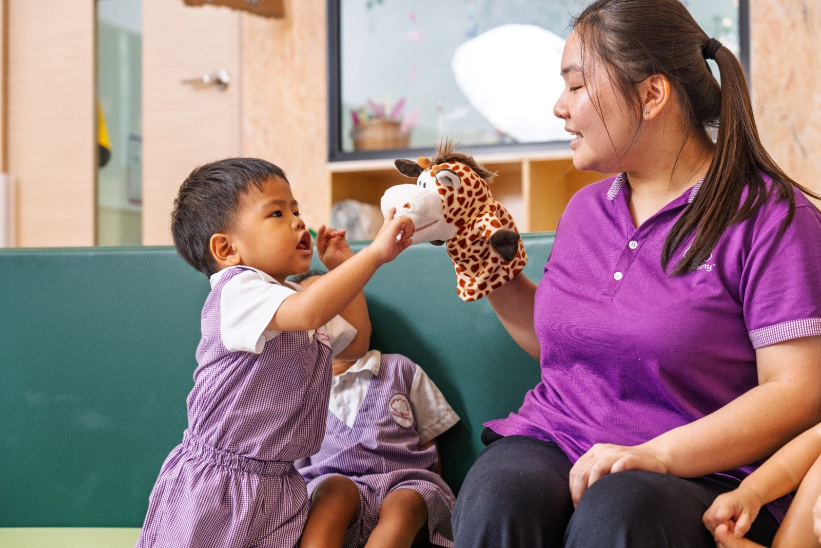 Teacher and child with puppet